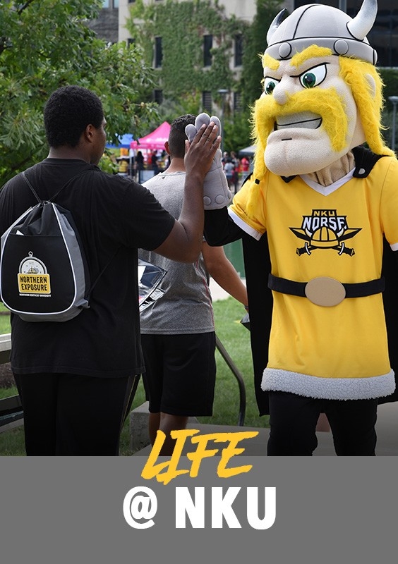 Life at 51: Student at an event giving Victor E. Viking a high-five